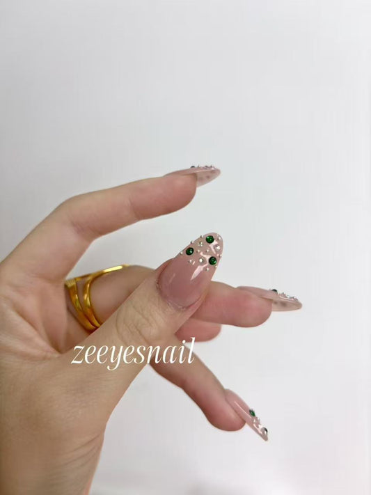 Blush Pink Almond Nails with Emerald Crystal Accents