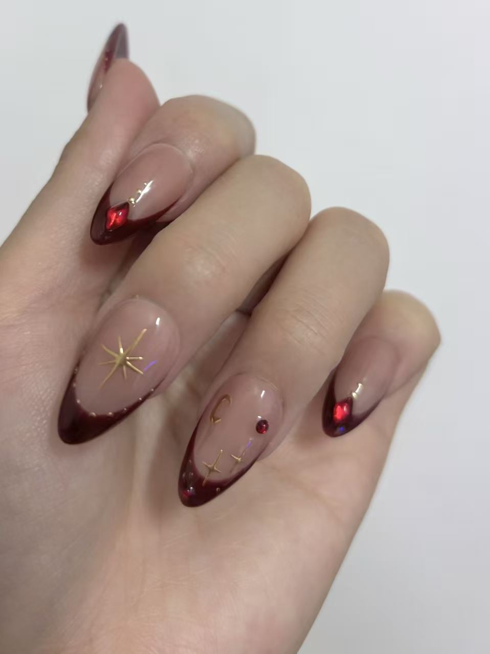 Burgundy French Almond Nails with Gold Accents