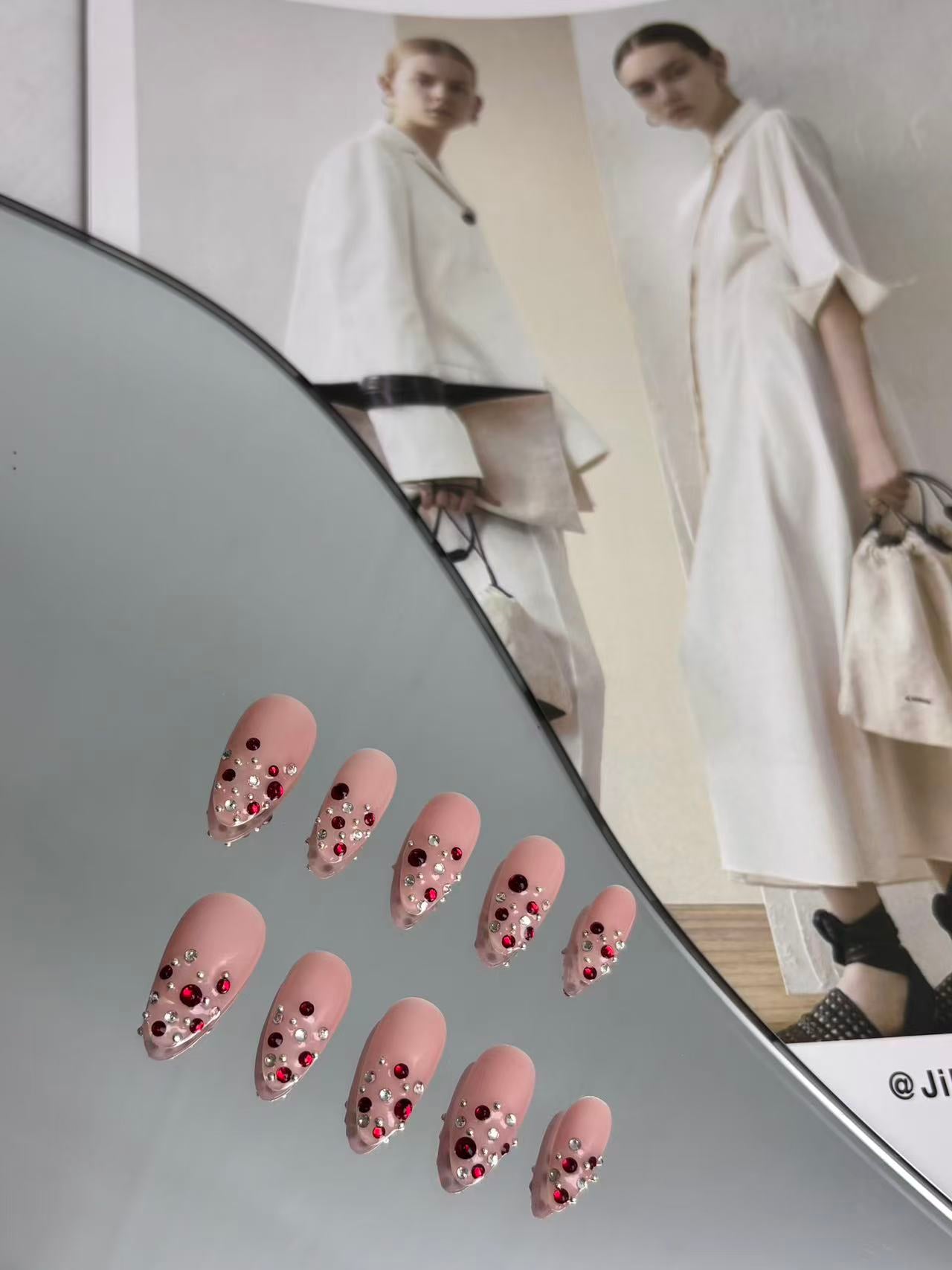 Blush Pink Almond Nails with Ruby Crystal Accents