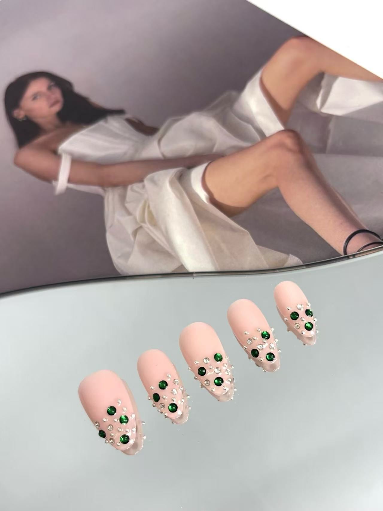 Blush Pink Almond Nails with Emerald Crystal Accents