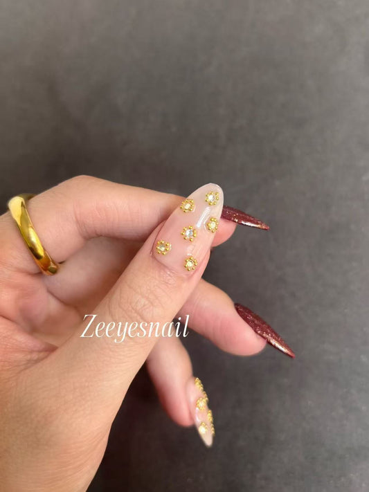 Burgundy Glitter Almond Nails with Gold Floral Accents